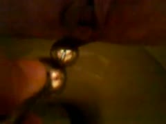 A teenage boy using a dildo to penetrate his own ass while urinating